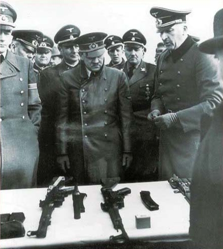 Hitler looking at weapons including an StG-44