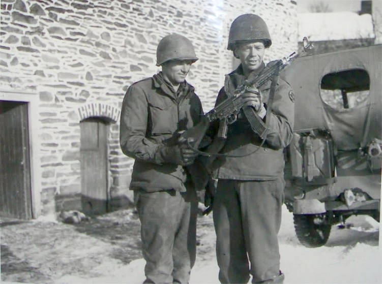 Two American Soldiers looking at an mp43